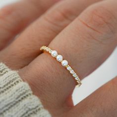 Beautiful pave band with three dainty pearls. So dainty and chic, it looks so cute on its own or stacked with other rings! Made of 925 Sterling Silver We use a THICK, DURABLE plating of 14K Gold, Rose Gold or Rhodium - for a piece that will last you years to come! Nickel-free & Hypoallergenic Width: 2mm Simple Pearl Ring Silver, Dainty Silver Jewelry Rings, 3 Pearl Ring, Simple Band Rings, Dainty Pearl Ring, Dainty Gold Ring Stack, Pretty Gold Jewelry, Pearl Rings In Silver, Prom Jewlrey