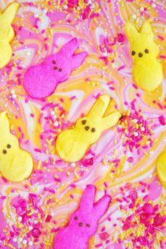 some peep - poop cookies are on a pink and yellow surface with sprinkles