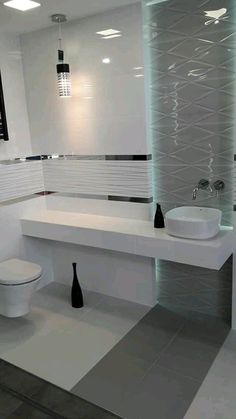 a white bathroom with two sinks and a toilet