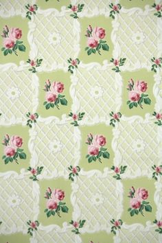 a green and white wallpaper with pink roses on the border in an ornate pattern