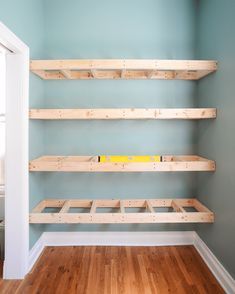 the empty room has wooden shelves in it