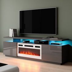 a television stand with a fire in the center