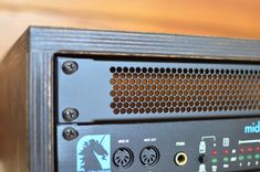 a close up view of the front panel of a stereo system on a wooden table