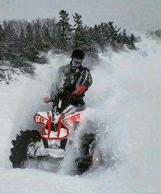 a man riding an atv in the snow