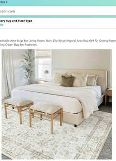 an image of a bed with pillows and blankets on top of it in a bedroom