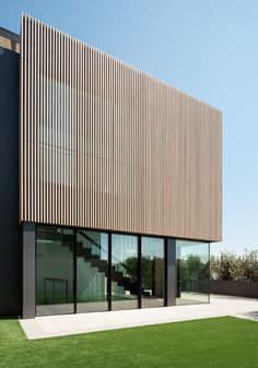 a modern building with grass in front of it