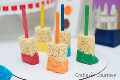 several popsicles made out of rice krispy kreme are sitting on a plate