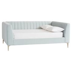 a light blue couch with white pillows on the top and bottom end, sitting in front of a white background