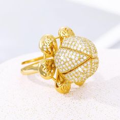 Elevate your style with the Adjustable Gold Plated Flower Bud Ring, a timeless piece of jewelry that adds a touch of elegance to any ensemble. Crafted with meticulous attention to detail, this ring features a delicate flower bud design plated in luxurious gold, exuding sophistication and charm. Designed to fit comfortably on any finger, this adjustable ring offers versatility and ease of wear for individuals of all ages and sizes. Whether you're dressing up for a special occasion or adding a hin Channel Set Rings, Gold Flower Ring, Vintage Jewellery Rings, Gold Leaves, Flower Plates, Zircon Ring, Flower Bud, Ring Collections, Flower Ring