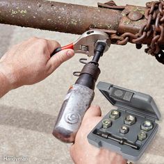 a man is holding a wrench and tool in his hand while working on an old pipe