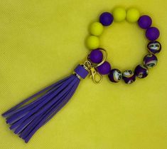 a bracelet with beads and tassels on a yellow background