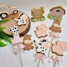 there are many farm animals on top of the cupcakes and cake picks that are decorated with fondant