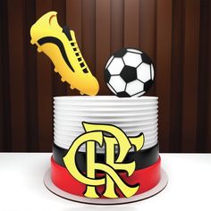 a cake with soccer shoes and a ball on top