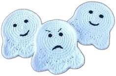 two white crocheted ghost rugs with faces drawn on the front and back