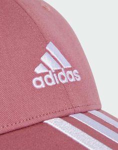 a red adidas hat with white stripes on it