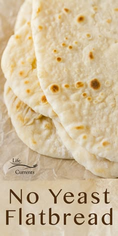 three flatbreads sitting on top of a piece of paper with the words, no yeast flatbread