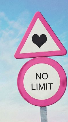 a pink and white street sign with a heart on it's side that says no limit