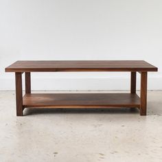 a wooden coffee table sitting on top of a white floor