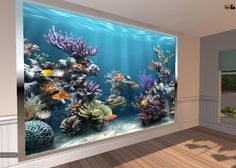 an aquarium with fish and corals is shown on the wall in this living room