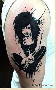 a woman with black hair and tattoos on her arm