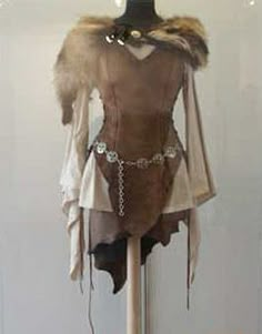 a mannequin is dressed up as a woman in a brown outfit with fur collar and cuffs