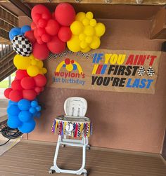 a birthday party with balloons on the wall and a sign that says if you can't it first, let youre last