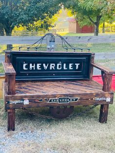 a bench made out of wood with the word chevrolet painted on it's back