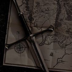 a pair of scissors sitting on top of an old map with the world in it