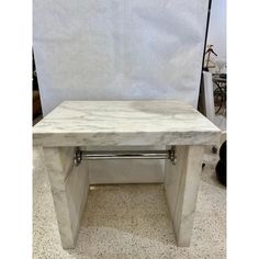 a white marble coffee table sitting on top of a floor