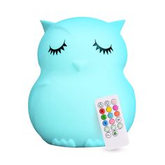 a blue owl with eyes closed holding a remote control