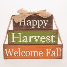 a wooden sign that says happy harvest, welcome fall and has a bow on it