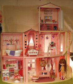 a doll house with all the furniture and accessories in it's pink color scheme