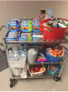 a grocery cart filled with food and drinks