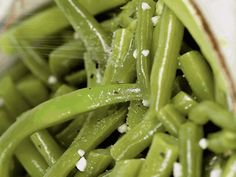 green beans with white stuff on them in a bowl