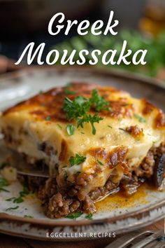 a close up of a plate of food on a table with the title greek moussaka