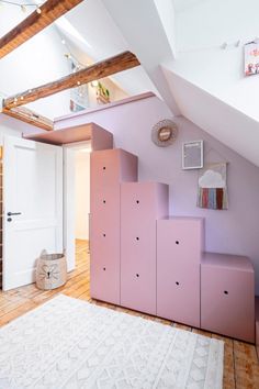 a room with some stairs in it and a rug on the floor next to it