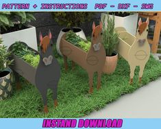 some paper animals are standing in the grass with plants and potted plants behind them