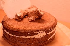 a chocolate cake with white frosting on top