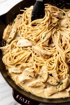 a skillet filled with chicken and noodles