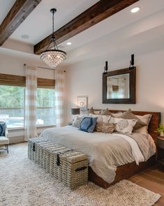 a bedroom with a large bed and wooden beams