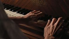 a person playing the piano with their hands