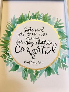 a painting with a bible verse in the center and green leaves around it on a white background