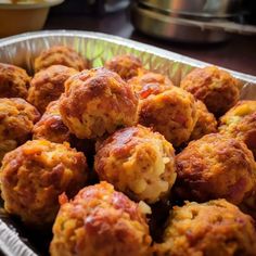 a metal pan filled with meatballs on top of a table