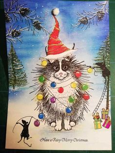 a christmas card with a cat wearing a santa hat on it's head and lights around its neck