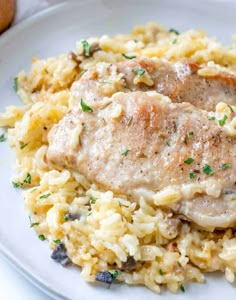 a white plate topped with rice and meat covered in gravy