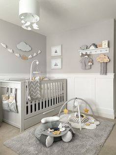 a baby's room is decorated in gray and white