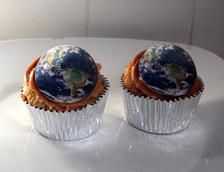 two cupcakes with the earth on top