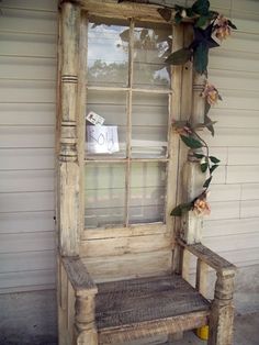 an old window sitting on top of a wooden bench