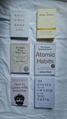 four books are laid out on a sheet