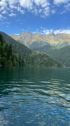 the water is very clear and blue with mountains in the background